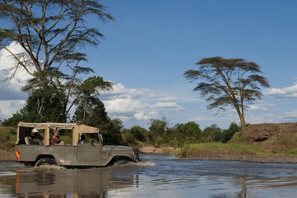 Safari jeep crossing river, Ol Pejeta Conservancy, Kenya.